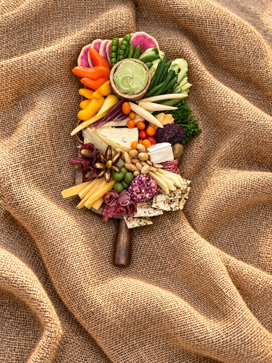A generous mixed board of vegetables, cheeses and savory accompaniments